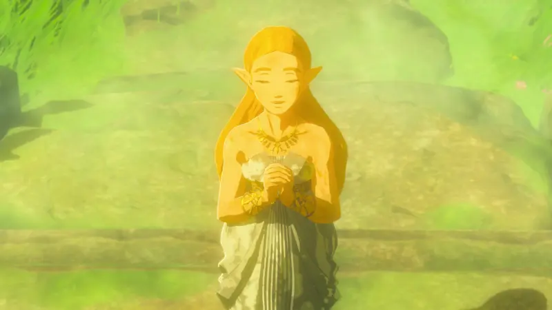 Princess Zelda with her eyes closed and hands clasped to her chest, bathed in green light in a clearing of moss-covered stones
