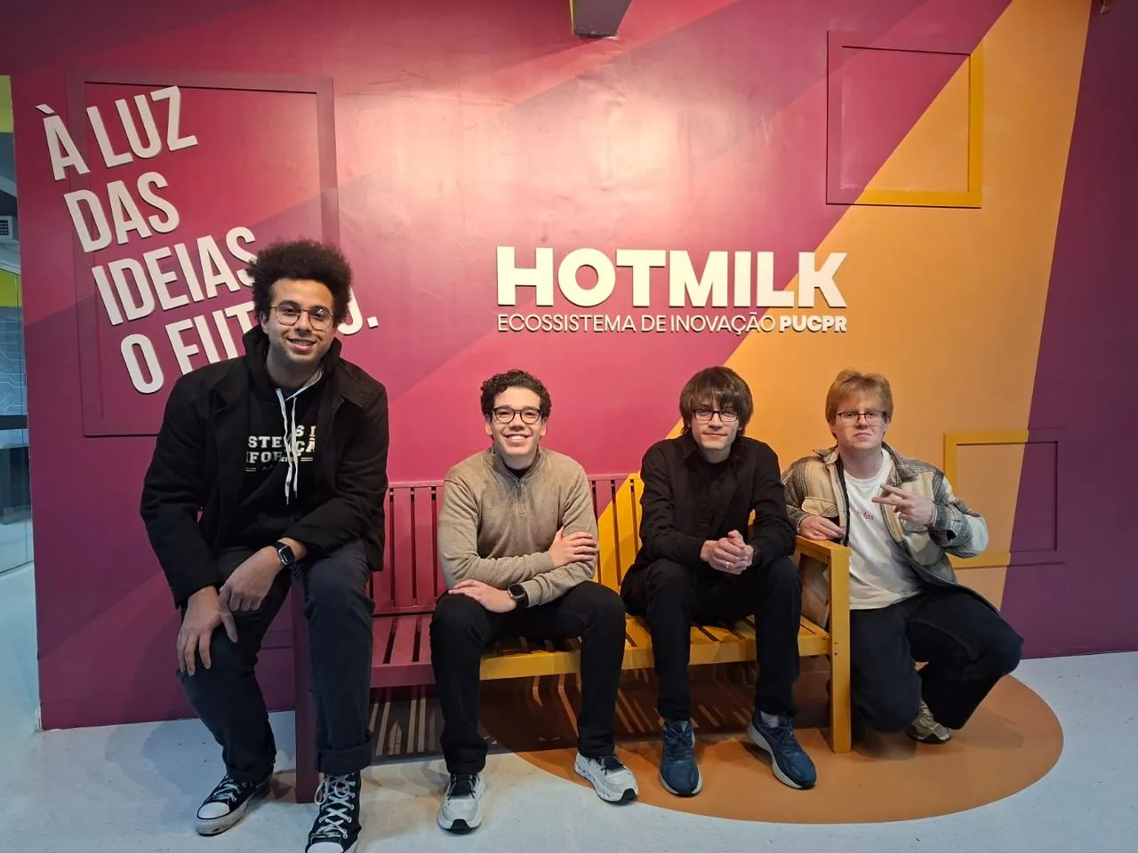 Four Nock team members posing at Hotmilk, PUCPR’s innovation ecosystem.
