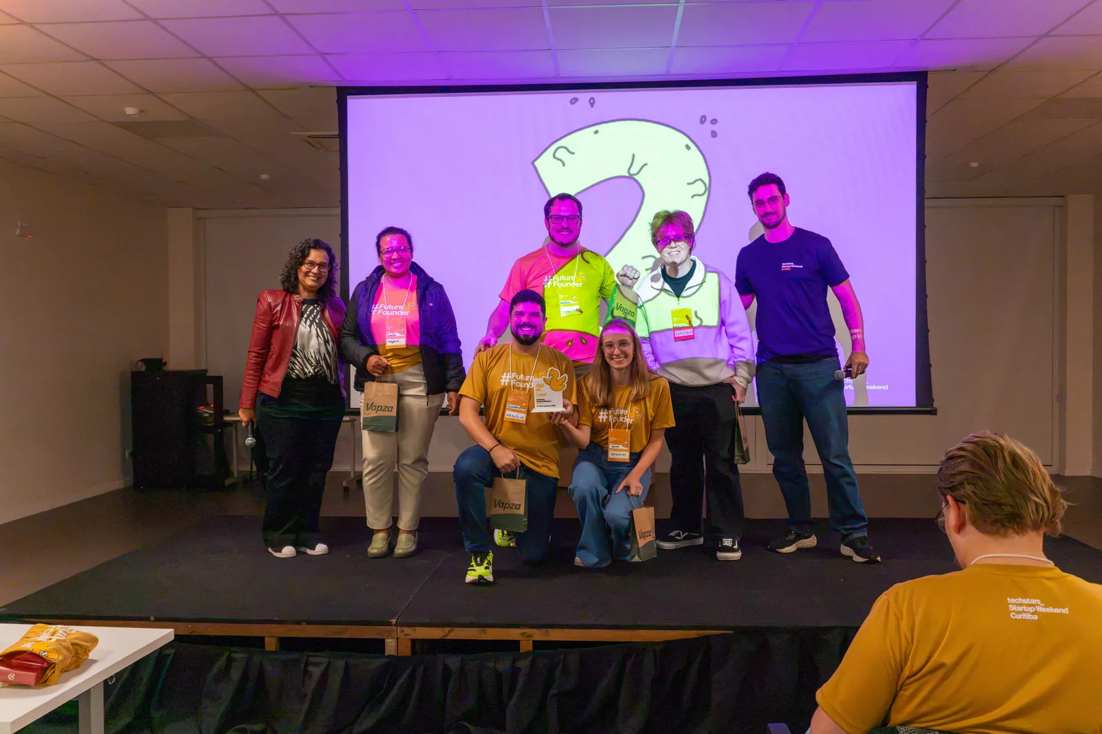 The FuelCheck team and event organizers onstage after the second-place award.