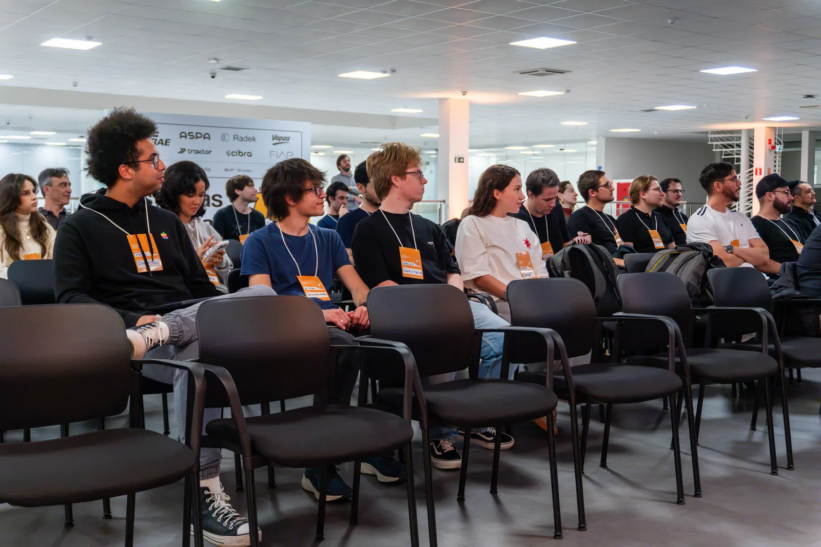 Startup Weekend participants seated and watching a presentation.