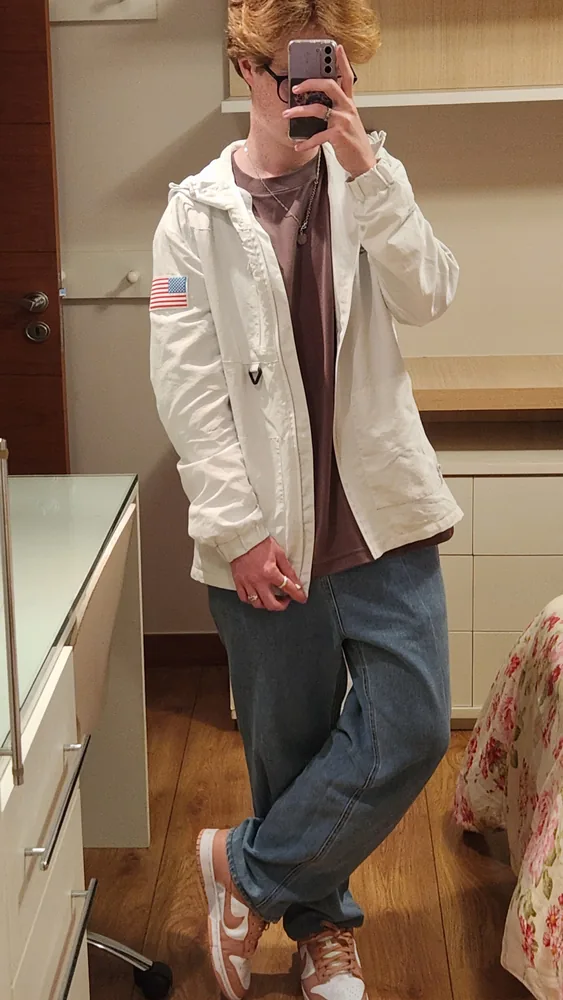 Mirror self-portrait of Carlos Leonardo wearing a light jacket