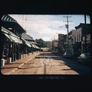 Cover of EDEN’s End Credits: an empty small-town street under a pale sky, shot through a faded film border, with EDEN and END CREDITS printed over it
